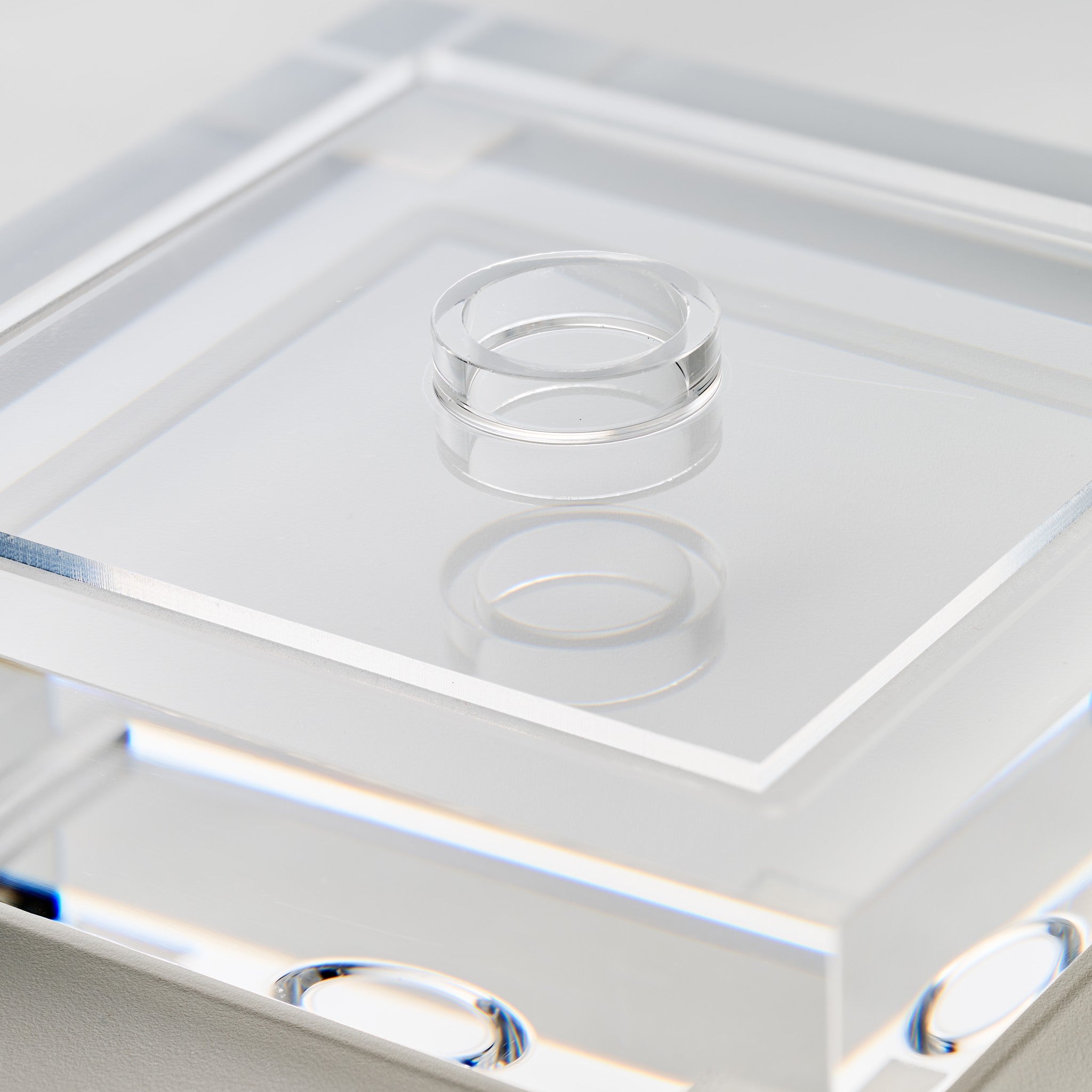 Close-up detail of the recessed clear seating collar that cradles the baseball inside the display case